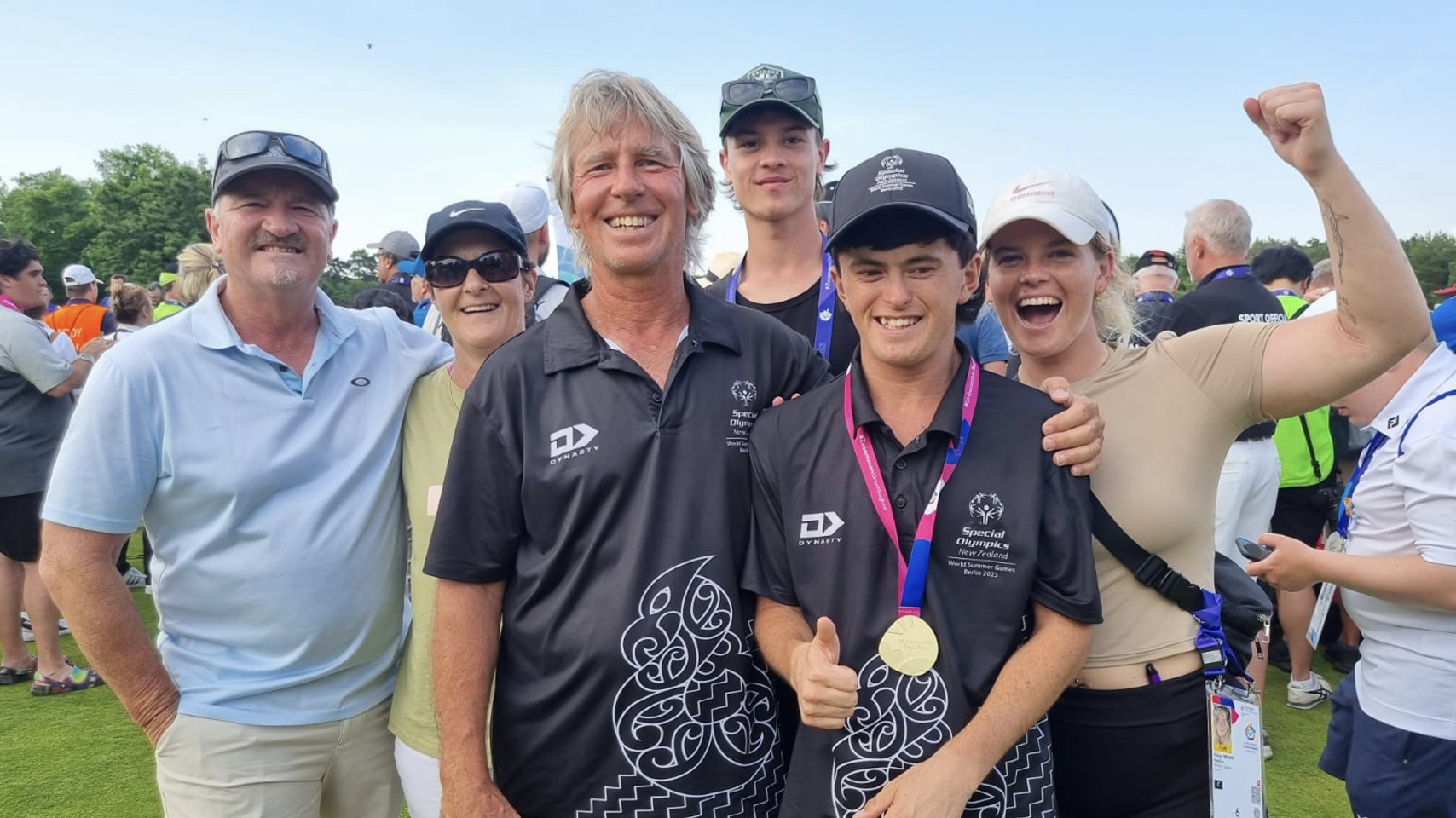 Surrounded by loved ones, Mitch Brown and his father Mike embrace whānau at the Berlin Special Olympics. Photo / Supplied