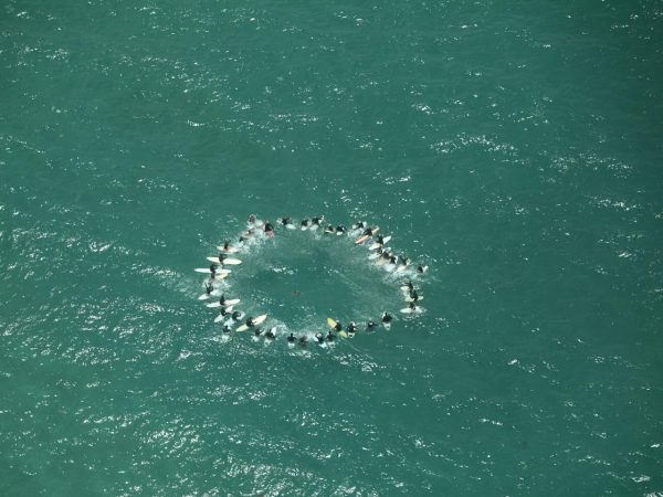 In a touching tribute, Aotea's surfers gathered at Medland's for a paddle out at 2 pm, as Mike's journey from the island took flight for the last time. Photo / Facebook
