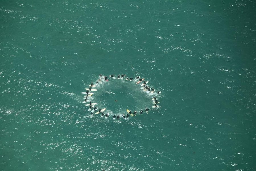 In a touching tribute, Aotea's surfers gathered at Medland's for a paddle out at 2 pm, as Mike's journey from the island took flight for the last time. Photo / Facebook