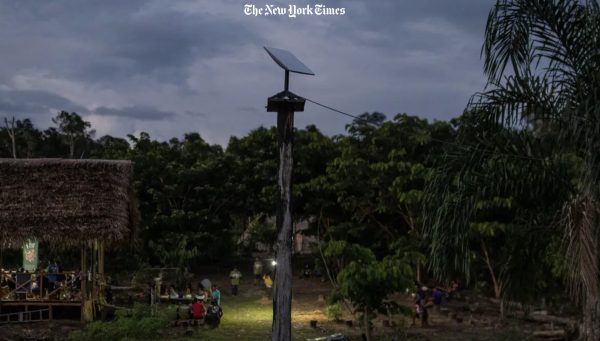 A Starlink antenna stands tall amidst the Marubo community, symbolizing the intersection of tradition and modernity as the tribe navigates the benefits and challenges of unfettered internet access. Photo / NYTimes