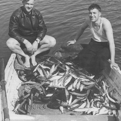 Two unidentified men with a remarkable fishing haul on Great Barrier Island, early 1900s. Can you identify them? Email editor@aoteagbi.news Photo / Supplied