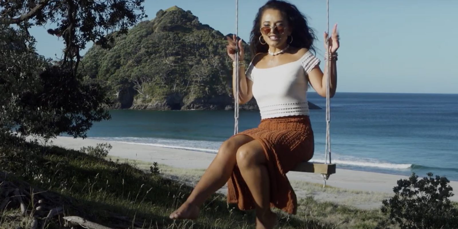 Waii in her element — against the wild, open backdrop of Great Barrier Island, where Bumble Bee feels right at home. Photo / Waii Music