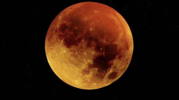Blood moon as dark skies reveal the total lunar eclipse.