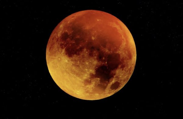 Blood moon as dark skies reveal the total lunar eclipse.