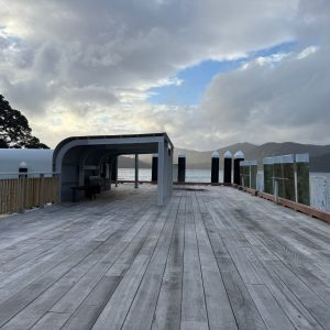 New hardwood benches sit beneath a steel-framed canopy at Tryphena Wharf, giving passengers shelter while they wait for ferries or collect freight.
