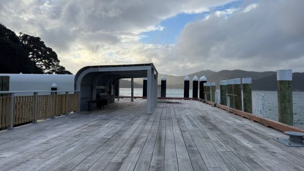 New hardwood benches sit beneath a steel-framed canopy at Tryphena Wharf, giving passengers shelter while they wait for ferries or collect freight.