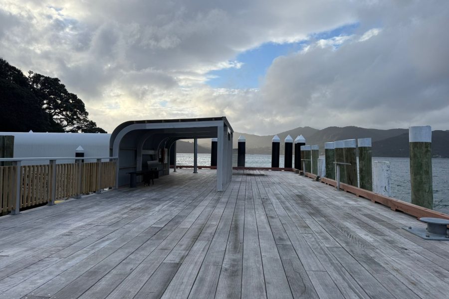 New hardwood benches sit beneath a steel-framed canopy at Tryphena Wharf, giving passengers shelter while they wait for ferries or collect freight.