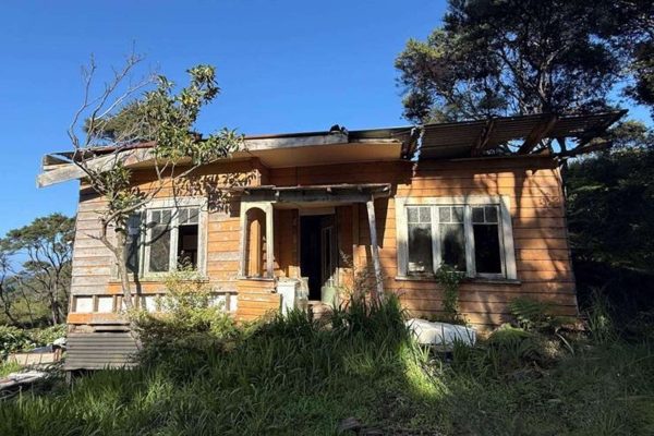 Weathered timber and rusting iron cling to what’s left of the old pioneer cottage on Blind Bay Road — soon to perhaps make way for a new build.