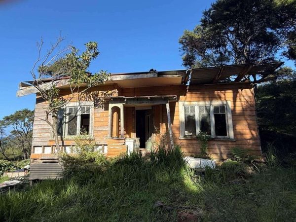 Weathered timber and rusting iron cling to what’s left of the old pioneer cottage on Blind Bay Road — soon to perhaps make way for a new build.
