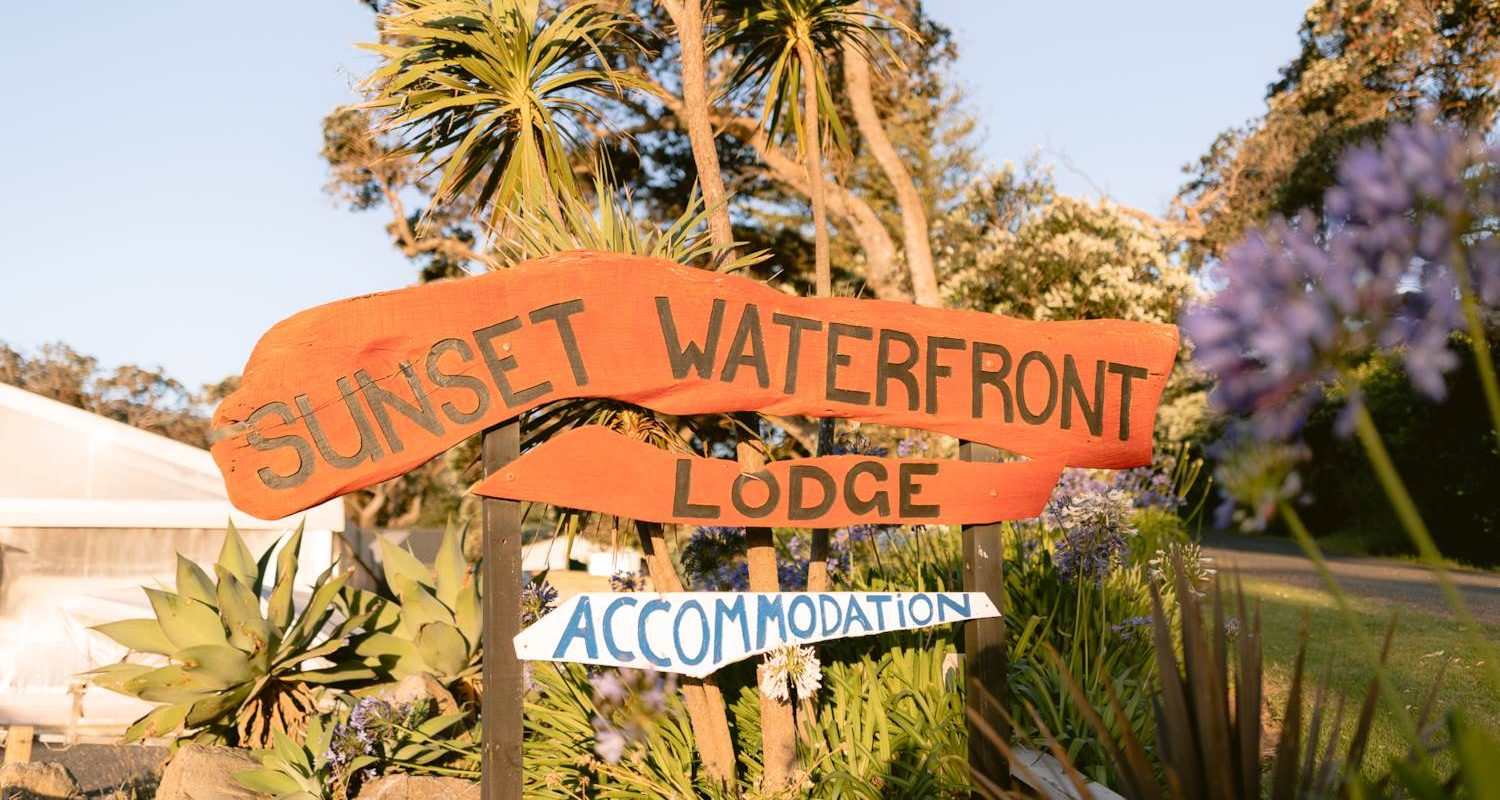 Sunset Waterfront Lodge sits opposite the beach at Mulberry Grove, a familiar landmark for visitors arriving in Tryphena.