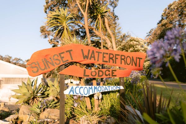 Sunset Waterfront Lodge sits opposite the beach at Mulberry Grove, a familiar landmark for visitors arriving in Tryphena.