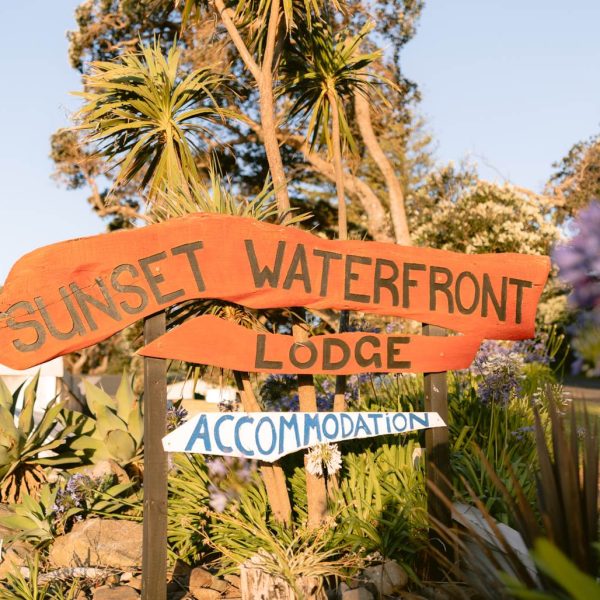 Sunset Waterfront Lodge sits opposite the beach at Mulberry Grove, a familiar landmark for visitors arriving in Tryphena.