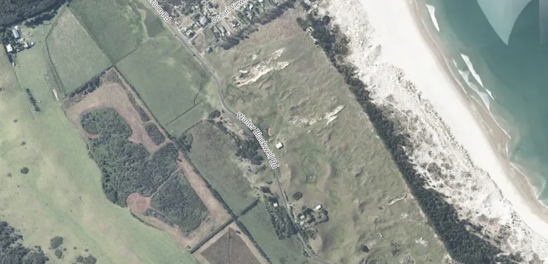 Aerial view of the Blackwell family’s Kaitoke farmland, showing the mānuka scrub and low-lying swamp flats at the centre of the Auckland Council investigation.
