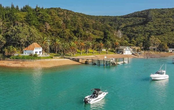 The RNZYS property at Bon Accord Harbour, Kawau Island — including the historic Lidgard House (left) — is set to be sold, despite opposition from some members.