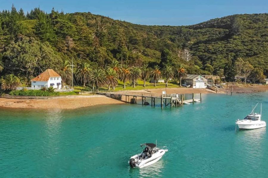 The RNZYS property at Bon Accord Harbour, Kawau Island — including the historic Lidgard House (left) — is set to be sold, despite opposition from some members.
